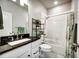 Bathroom with a shower and tub, white cabinetry, and dark countertops at 5771 Slate River Pl, Brighton, CO 80601