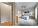 Spacious bedroom featuring a large window, ceiling fan, and bathroom access at 5771 Slate River Pl, Brighton, CO 80601