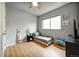 Bright bedroom featuring a ceiling fan, hardwood floors, and ample natural light at 5771 Slate River Pl, Brighton, CO 80601