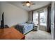 Bedroom with a ceiling fan, and windows providing natural light at 5771 Slate River Pl, Brighton, CO 80601