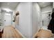 Bright entryway with wood floors, coat closet, and access to the laundry room at 5771 Slate River Pl, Brighton, CO 80601