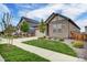 Lovely home with manicured lawn and tasteful stone accents, showcasing suburban charm and curb appeal at 5771 Slate River Pl, Brighton, CO 80601