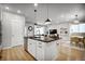 Stylish kitchen featuring an island with bar seating, stainless steel appliances, and modern finishes at 5771 Slate River Pl, Brighton, CO 80601