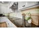 Close-up of a modern kitchen showcasing dark granite countertops, stainless steel appliances, and sleek white cabinetry at 5771 Slate River Pl, Brighton, CO 80601