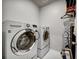 Laundry room featuring a washer and dryer and tile flooring at 5771 Slate River Pl, Brighton, CO 80601