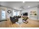 Bright and airy living room with hardwood floors, a modern ceiling fan, and a comfortable seating area at 5771 Slate River Pl, Brighton, CO 80601