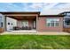 Covered patio with outdoor seating overlooking a well-maintained lawn at 5771 Slate River Pl, Brighton, CO 80601