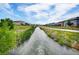Scenic water canal surrounded by green spaces and walking paths in this peaceful community at 5771 Slate River Pl, Brighton, CO 80601