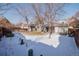 Winter backyard features a shed, patio, and snowy lawn, all within a fenced perimeter at 18908 E Napa Dr, Aurora, CO 80013