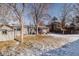 Winter backyard view showcasing a covered patio, snowy lawn, and privacy fencing at 18908 E Napa Dr, Aurora, CO 80013