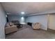 Spacious finished basement featuring neutral paint, plush carpet, and two sofas for relaxation and entertaining at 18908 E Napa Dr, Aurora, CO 80013