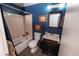 Cozy bathroom with blue walls, mosaic tile flooring, and framed art adds a unique touch to the space at 18908 E Napa Dr, Aurora, CO 80013