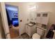 Compact bathroom features tile flooring, modern vanity, and built in shelving for storage at 18908 E Napa Dr, Aurora, CO 80013