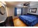 Bedroom featuring hardwood floors, ceiling fan, and a large bed with a plush blue comforter at 18908 E Napa Dr, Aurora, CO 80013