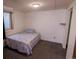Simple bedroom featuring a small bed with patterned bedding and a window for natural light at 18908 E Napa Dr, Aurora, CO 80013