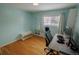 Bedroom with hardwood floors, light blue walls, and white furniture at 18908 E Napa Dr, Aurora, CO 80013