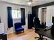 Comfortable bedroom with a black accent wall, hardwood floors, and closet space at 18908 E Napa Dr, Aurora, CO 80013