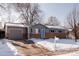 Single-Gathering home with a gray exterior, a brick foundation, and an attached garage and front yard in winter at 18908 E Napa Dr, Aurora, CO 80013