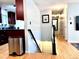 Hallway with hardwood floors that leads to the basement, kitchen, and other rooms at 18908 E Napa Dr, Aurora, CO 80013