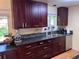 A modern kitchen with stainless steel appliances and stylish dark wood cabinets at 18908 E Napa Dr, Aurora, CO 80013