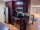 A fully equipped kitchen with modern appliances, dark cabinets, and an adjacent dining area at 18908 E Napa Dr, Aurora, CO 80013