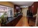 Well-lit kitchen features dark wood cabinets, stainless steel appliances, and a large window at 18908 E Napa Dr, Aurora, CO 80013