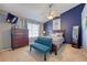 Comfortable bedroom featuring a blue accent wall and ample natural light at 19225 E Carolina Pl # 102, Aurora, CO 80017