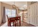 Cozy dining area with wood floors, a modern light fixture, and a view of the adjoining kitchen at 19225 E Carolina Pl # 102, Aurora, CO 80017