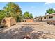 Large backyard featuring a storage shed, mature trees, stone landscaping and a hot tub at 17601 E Eastman Pl, Aurora, CO 80013