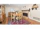 Dining room features a brick fireplace, antique dining set, and skull wall decor at 17601 E Eastman Pl, Aurora, CO 80013