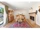 Dining room showcases a brick fireplace, antique dining set, and sliding glass door at 17601 E Eastman Pl, Aurora, CO 80013