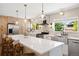 Light filled kitchen with stainless steel appliances, white countertops, pendant lights and wooden cabinets at 17601 E Eastman Pl, Aurora, CO 80013