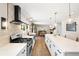 Bright kitchen featuring a gas range, white countertops, sleek black hardware, and an island with pendant lighting at 17601 E Eastman Pl, Aurora, CO 80013