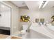 Well-lit bathroom featuring a shower with a black tile bench and a white vanity at 29432 Camelback Ln, Evergreen, CO 80439