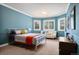 Bright bedroom with teal walls, white trim, natural light, and modern furnishings for a comfortable and stylish space at 29432 Camelback Ln, Evergreen, CO 80439