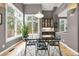 Sunlit dining area with glass top table and wood floors at 29432 Camelback Ln, Evergreen, CO 80439