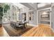 Bright dining room featuring large windows, wood floors, and a modern light fixture at 29432 Camelback Ln, Evergreen, CO 80439