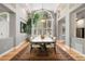 Sunlit dining room featuring hardwood floors, a large table, and abundant natural light at 29432 Camelback Ln, Evergreen, CO 80439