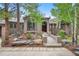 Charming home with a bridge entrance, beautiful landscaping, and mature trees at 29432 Camelback Ln, Evergreen, CO 80439