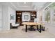 Home office featuring custom bookcases, wood desk, and neutral carpeting at 29432 Camelback Ln, Evergreen, CO 80439