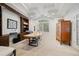 Office featuring wood desk, custom bookcase and neutral carpeting at 29432 Camelback Ln, Evergreen, CO 80439