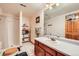 Traditional bathroom featuring a walk-in shower, nice natural light, and a vanity with storage at 1310 Spinnaker Trl, Monument, CO 80132