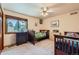 Bright bedroom featuring two beds, natural light from a large window, and a ceiling fan at 1310 Spinnaker Trl, Monument, CO 80132