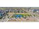 Community aerial view with tennis courts, playground, and well-maintained green spaces, highlighting recreational amenities at 9768 E 62Nd Dr, Denver, CO 80238