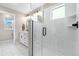 Bright bathroom with modern shower featuring white subway tile and glass enclosure and a double sink vanity at 9768 E 62Nd Dr, Denver, CO 80238