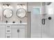 Modern bathroom featuring double vanity, quartz countertop, black fixtures, and subway tiled shower at 9768 E 62Nd Dr, Denver, CO 80238