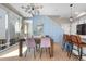 Bright dining room with modern chandelier, stylish chairs, and access to outdoor patio at 9768 E 62Nd Dr, Denver, CO 80238