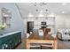 Open dining room featuring a wood table with pastel chairs and adjacent kitchen at 9768 E 62Nd Dr, Denver, CO 80238