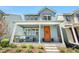 Charming home with a cozy front porch and vibrant orange front door at 9768 E 62Nd Dr, Denver, CO 80238
