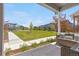 Relaxing front porch overlooking a well-maintained lawn and picturesque neighborhood street at 9768 E 62Nd Dr, Denver, CO 80238